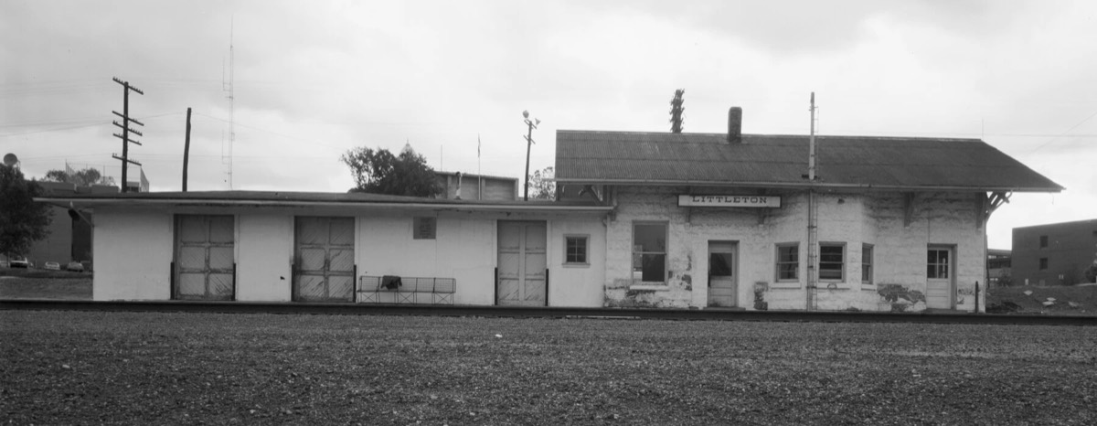 The Denver and Rio Grande Western railroad depot in Littleton, a low stone building with a LITTLETON sign under its eaves.
